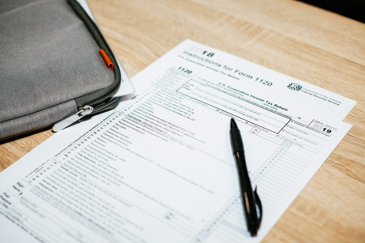 a ballpoint pen lying on tax documents