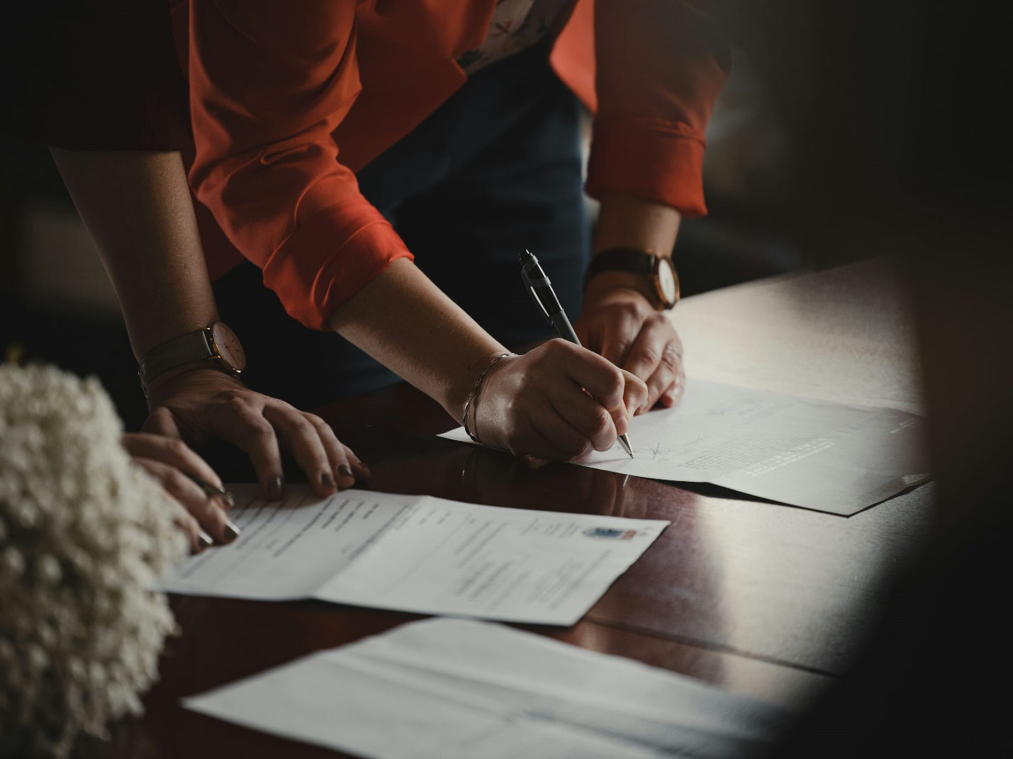 an individual signing a document