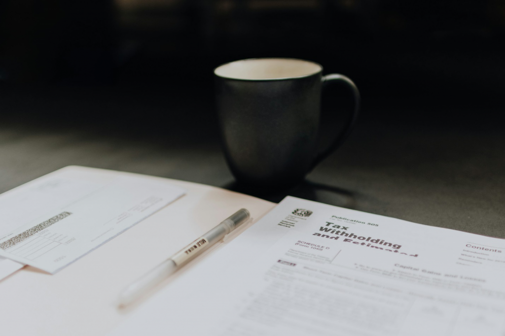 tax documentation and a mug on a table