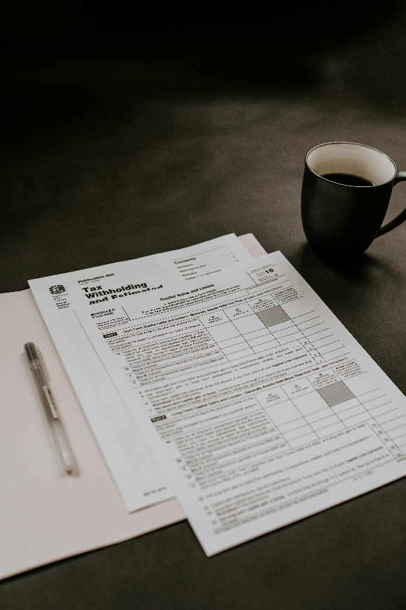 tax documents placed next to a mug