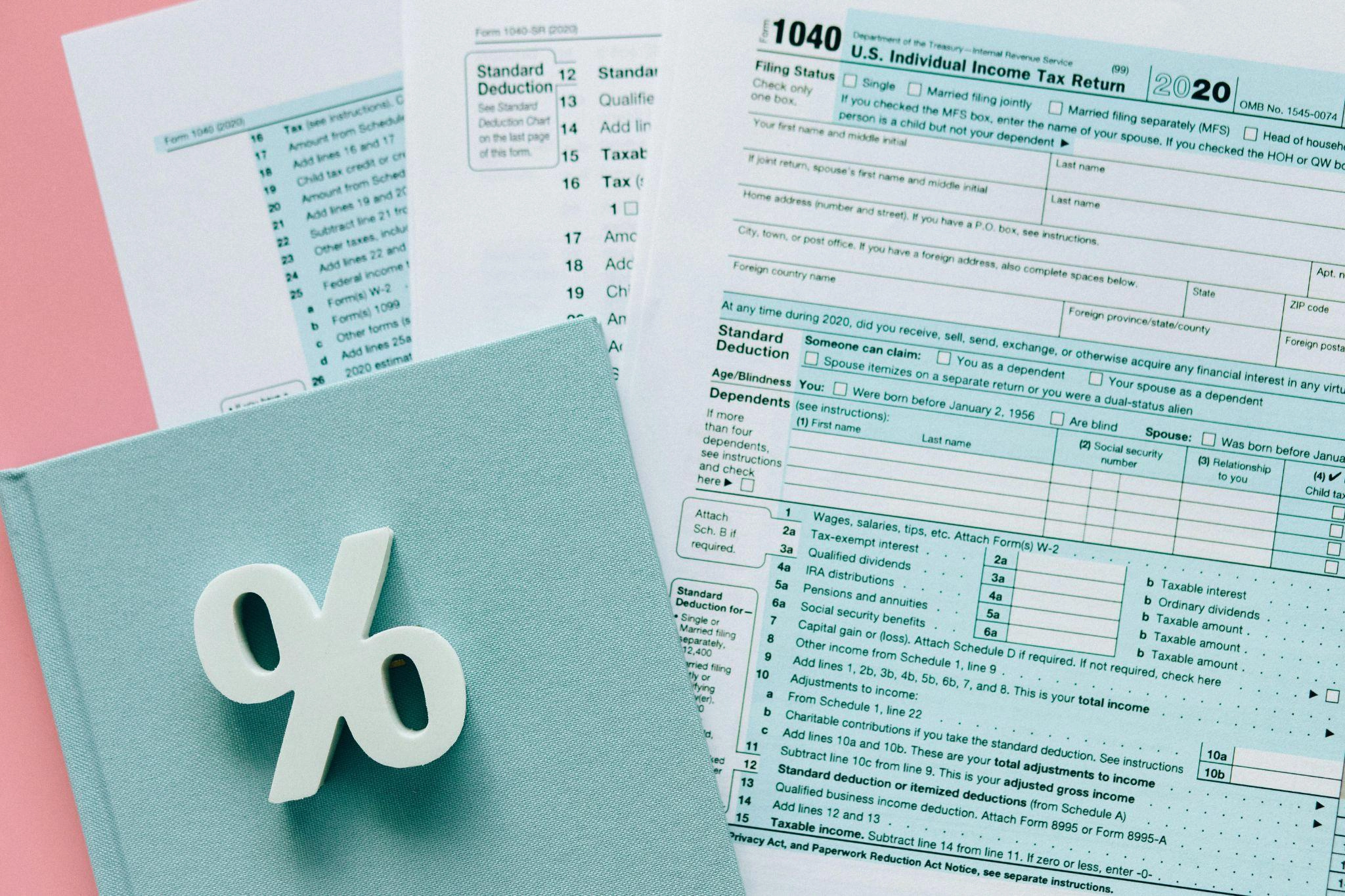 A cutout of a percentage sign placed beside a tax form