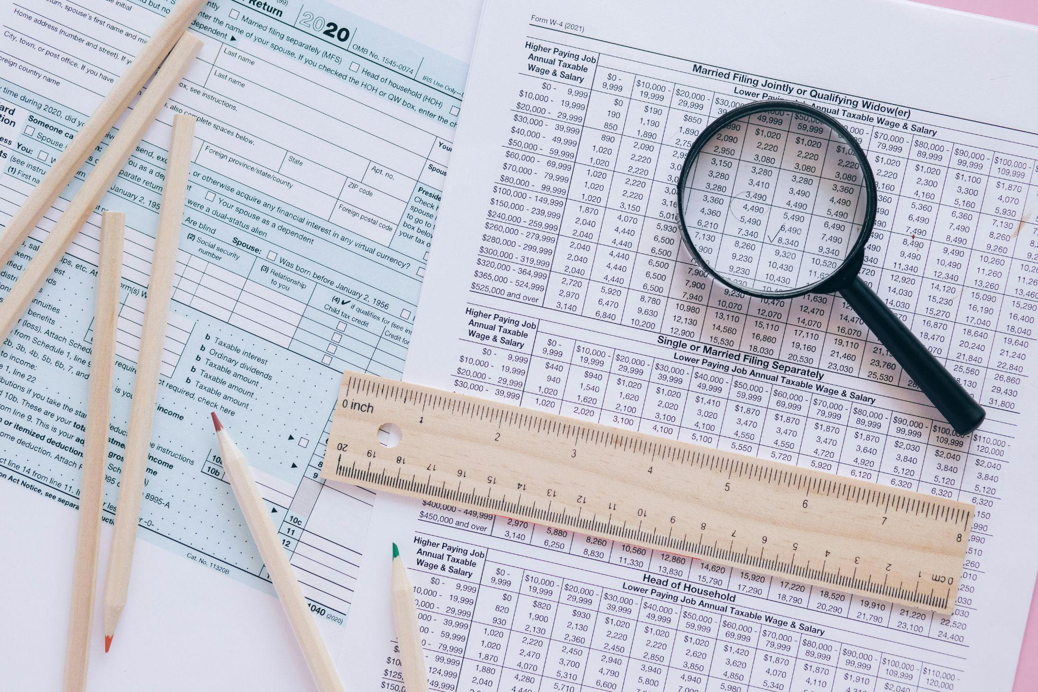 A tax form with a magnifying glass