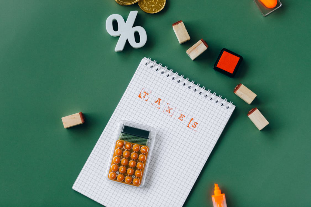 a notebook and calculator placed on a green surface